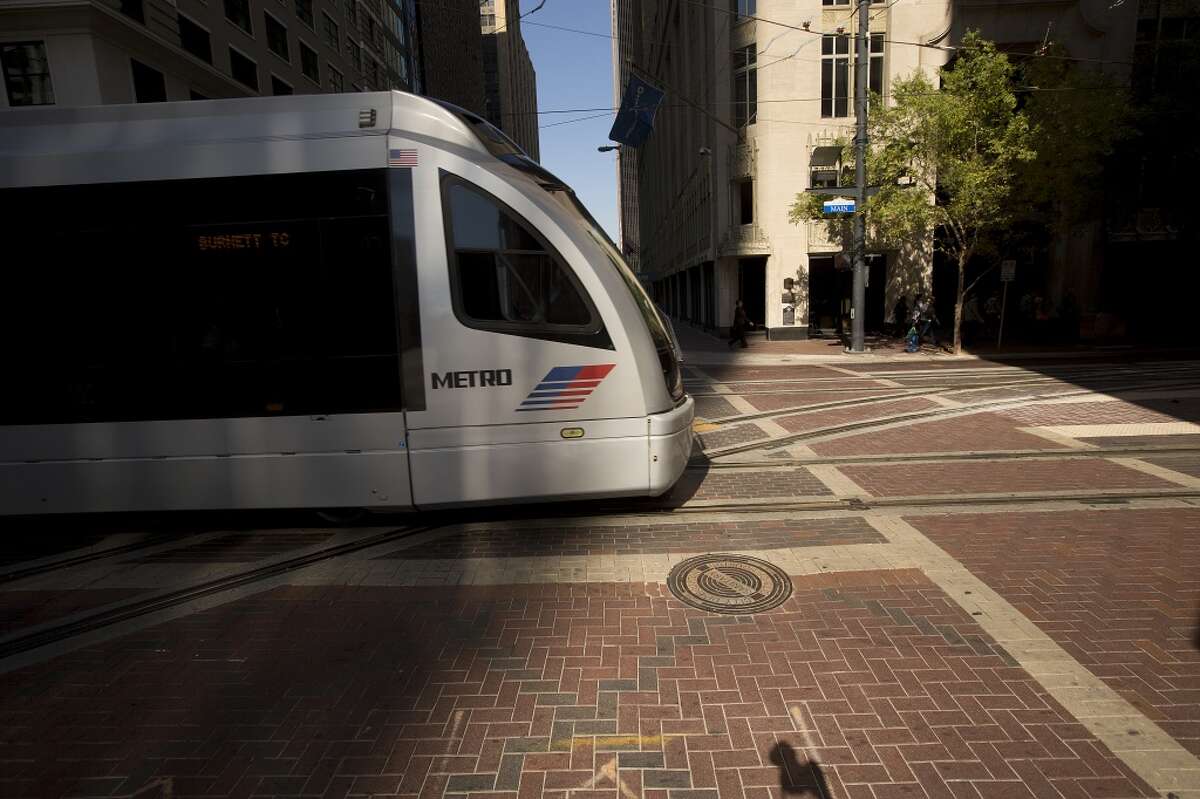 A Metro Red Line train makes its way down Main Street at Capitol past the new tracks for the Green and Purple lines on Oct. 22. ( Johnny Hanson / Houston Chronicle )