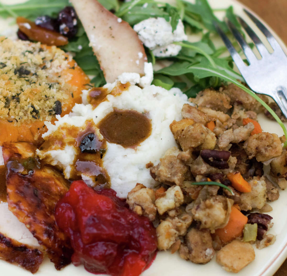 Eat hearty: cider-brined turkey with sage gravy, peach cranberry sauce, mashed potatoes, sausage pecan stuffing, arugula pear salad, sweet potatoes.