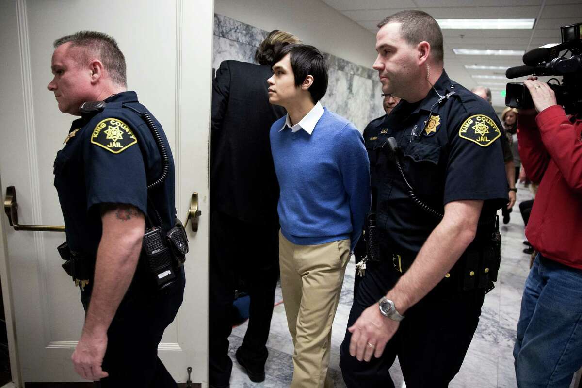 Thomasdinh Bowman, center, is escorted into court to stand on trial after being accused of the 2012 thrill killing of Yancy Noll, photographed Wednesday, November 19, 2014, at the King County Superior Court in Seattle, Washington. Prosecutors claim Bowman researched how to get away with murder before pulling up beside Noll and killing him at a Maple Leaf neighborhood intersection.