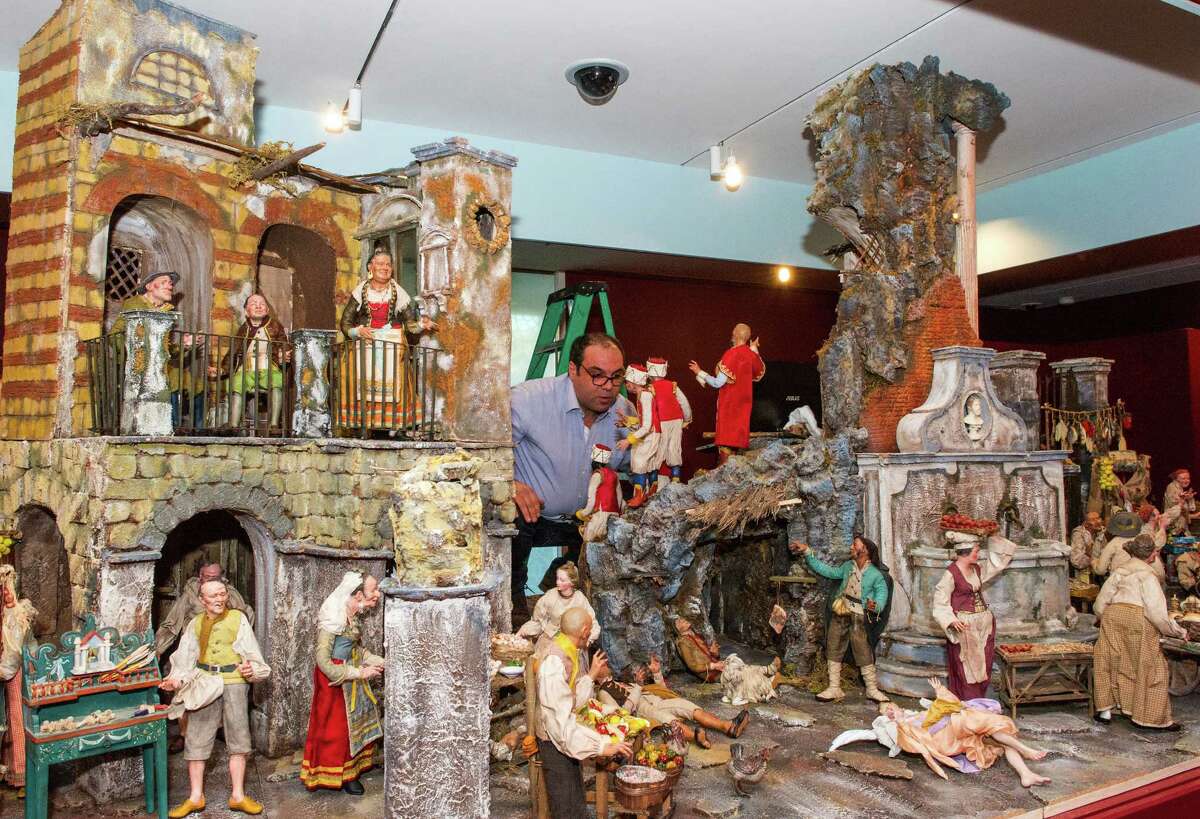 Artist Antonio Cantone inspects his work of installing more than 100 figurines on a 15-foot-wide Neapolitan crèche at the Knights of Columbus Museum in New Haven.