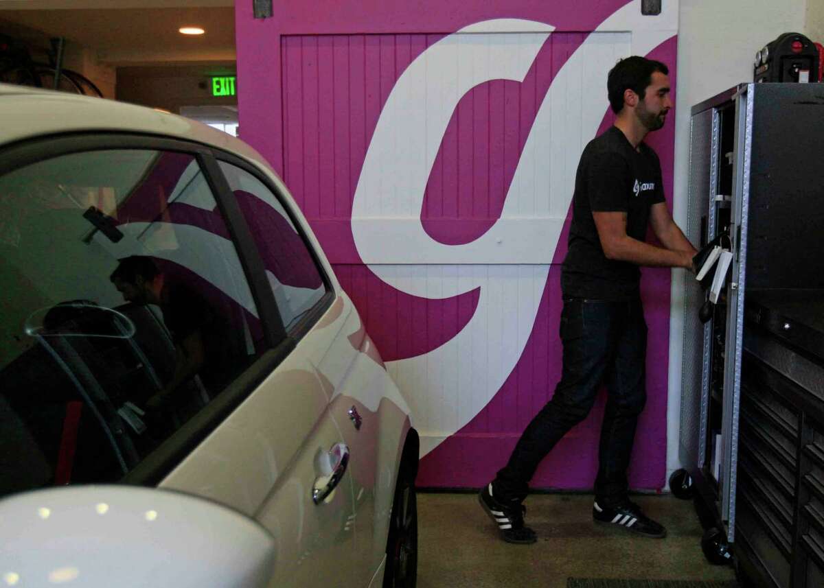 West Pesina, a fleet associate at Getaround, works in the garage at the car-sharing company’s headquarters on Harrison Street in San Francisco.