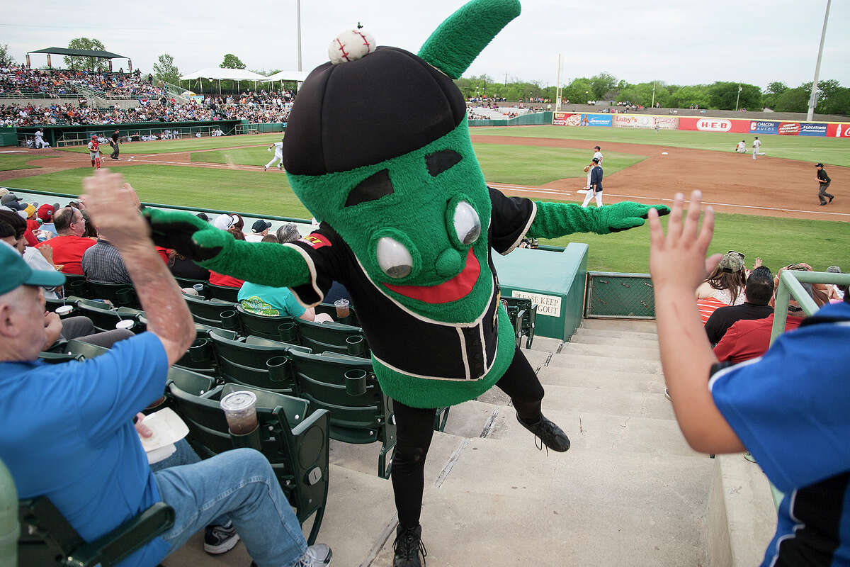 Joe Tinti gets a high-five from Ballapeno, one of the Missions mascots at the home opener against the Springfield Cardinals, Thursday, April 10, 2014 at Wolff stadium.