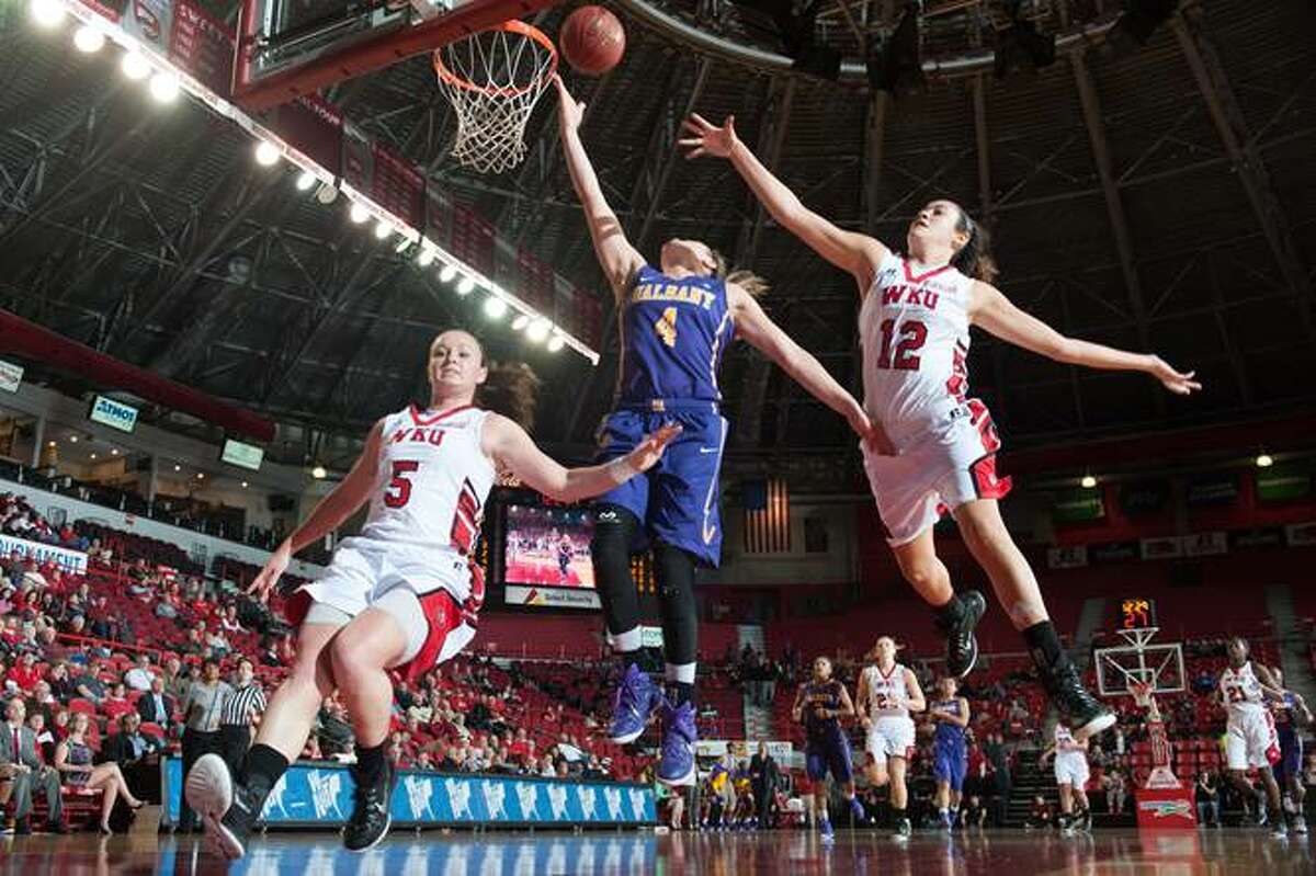 UAlbany's Sarah Royals goes to the basket between Western Kentucky defenders Micah Jones, left, and Kendall Noble during their preseason WNIT semifinal on Thursday, Nov. 20, 2014. (Joshua Lindsey / Special to the Times Union)