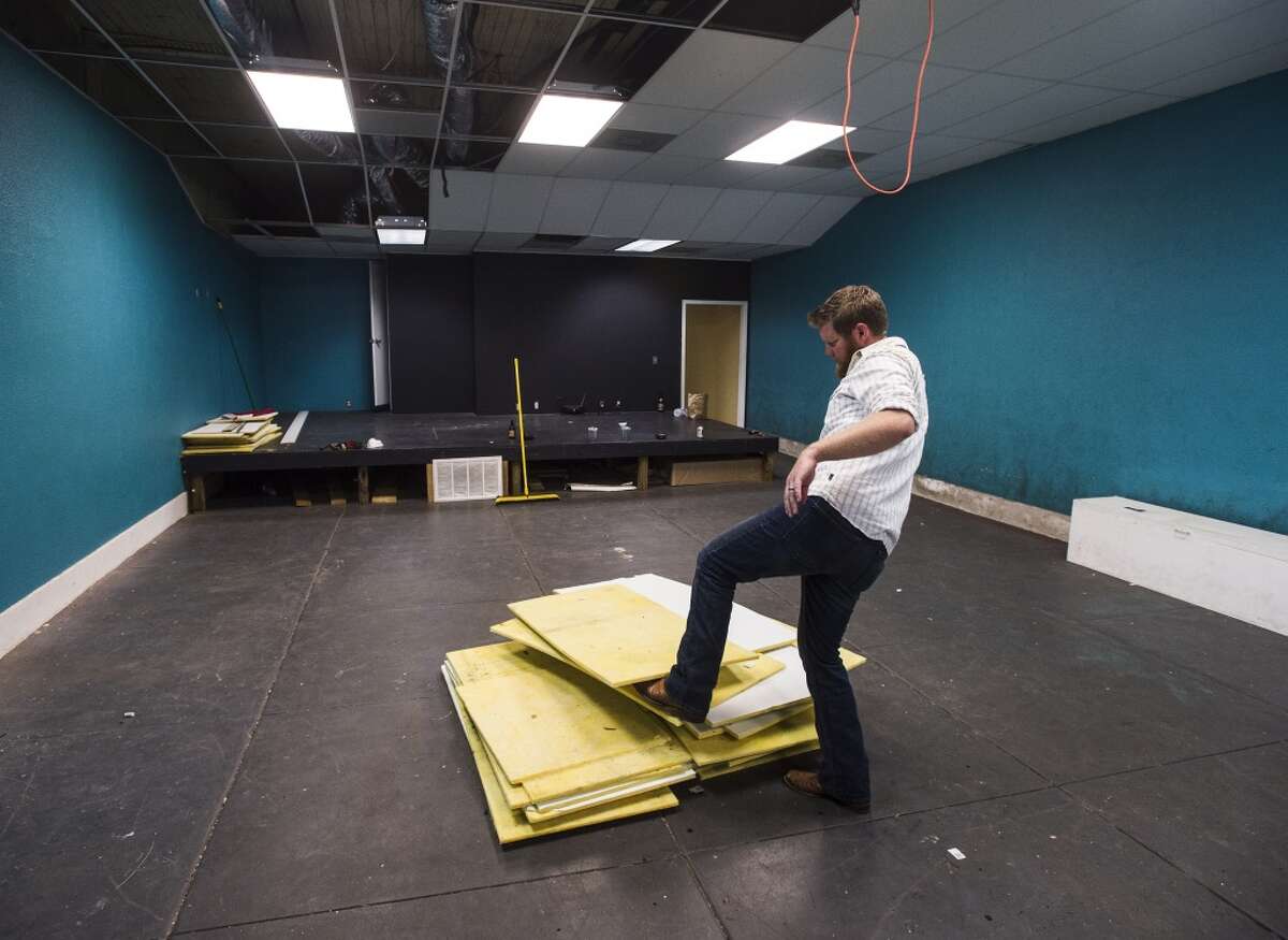 Tyler Blount shifts a pile of ceiling tiles Monday afternoon. Blount is renovating a building in downtown Port Neches to accommodate his business, the Neches Brewing Company. Photo taken Monday 11/10/14 Jake Daniels/@JakeD_in_SETX