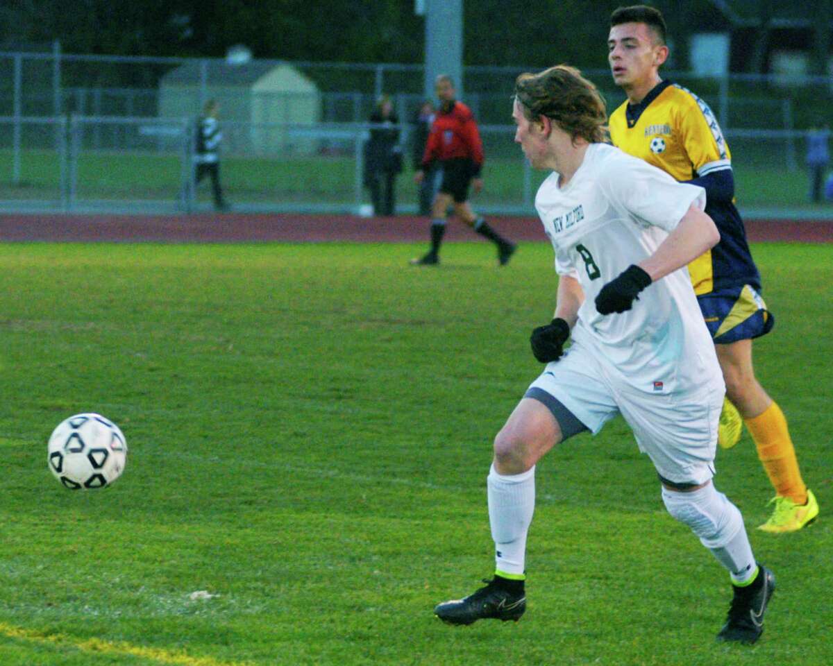 The Green Wave's Blaine McMahon gets the angle to deliver a pass to a teammate during New Milford High School boys' soccer's state class 'LL' tournament victory over Kennedy of Waterbury, Nov. 3, 2014 at NMHS.