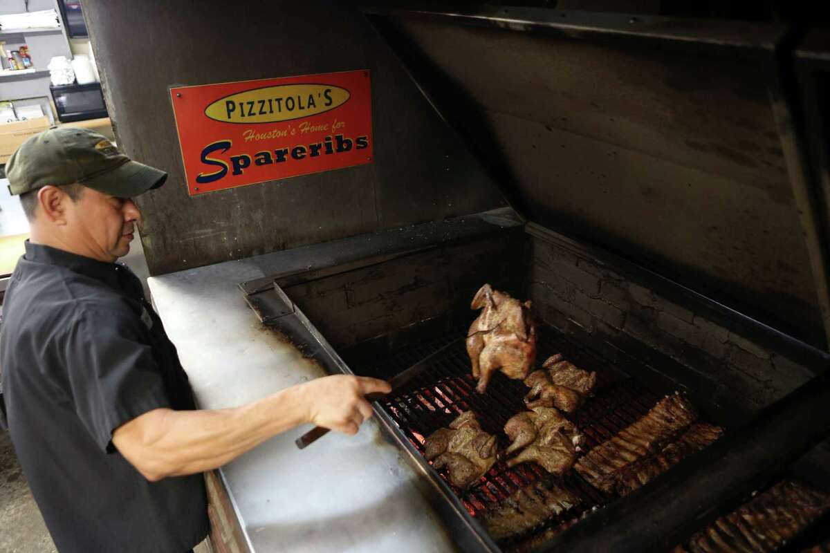 PIzzitola's Bar-B-Cue David Reynoso handles meat cooking in the brick pit at Pizzitola's Barbecue. The restaurant has been on Shepherd for many years after moving from its original location due to the construction of Interstate 10.