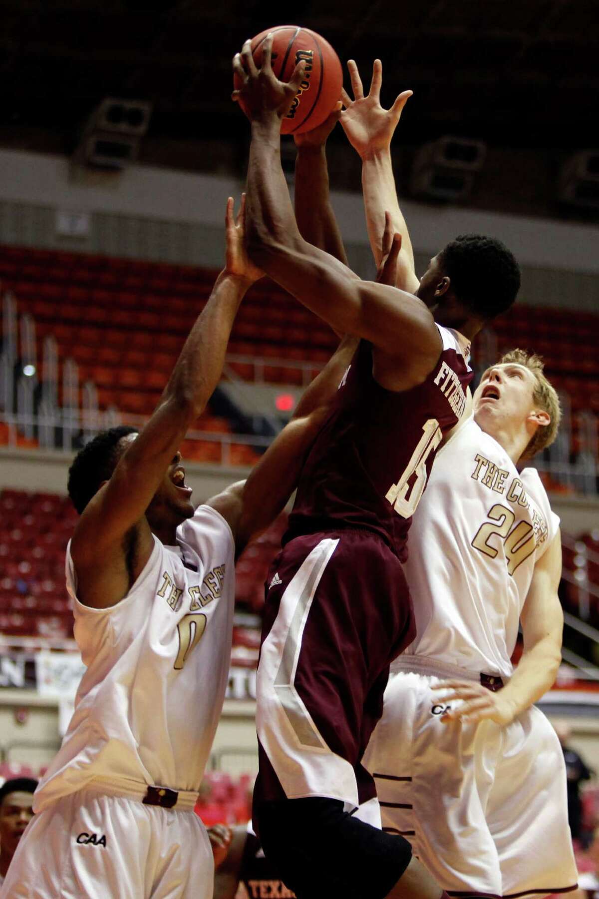 College of Charleston forward Donovan Gilmore, left, and teammate Canyon Barry, battle for a rebound against Texas A&M forward Davonte Fitzgerald during a NCAA college basketball game in San Juan, Puerto Rico, Friday, Nov. 21, 2014. (AP Photo/Ricardo Arduengo)