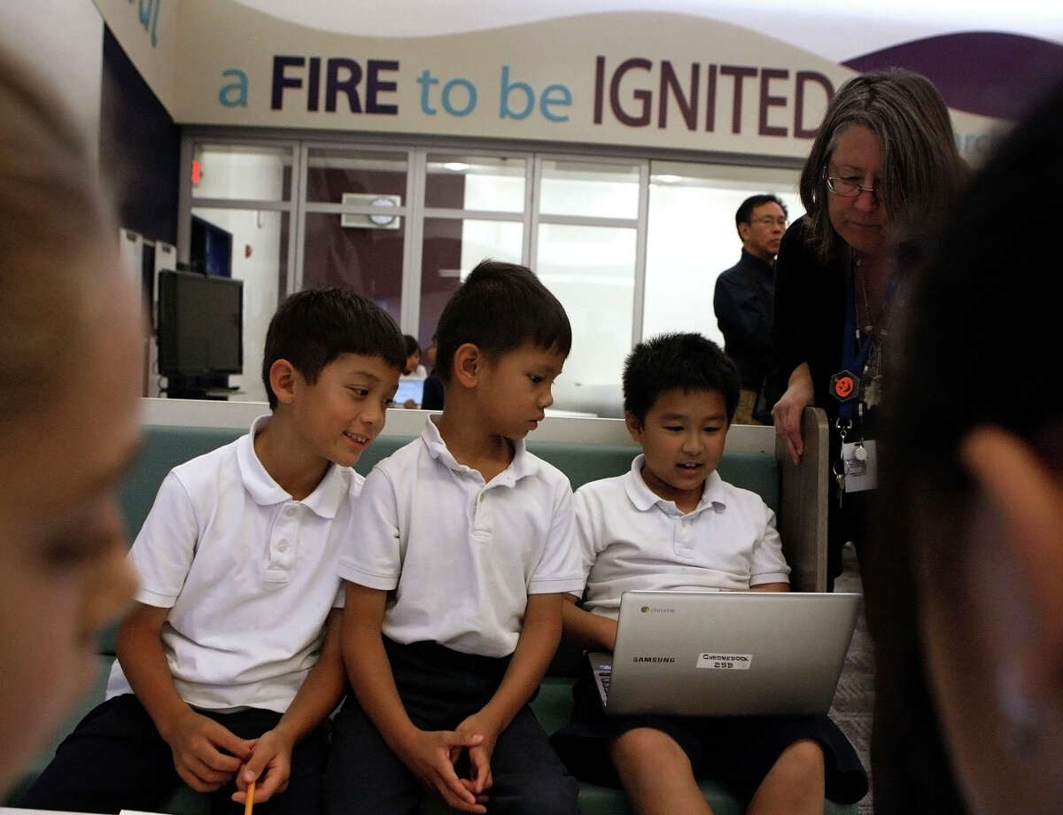Third-graders Alex Lu (left), Richie Ngo and Ray Chuang use a Chromebook computer to research Indian tribes at Marshall Pomeroy Elementary School in Milpitas. Chromebooks are becoming more popular for use in schools.