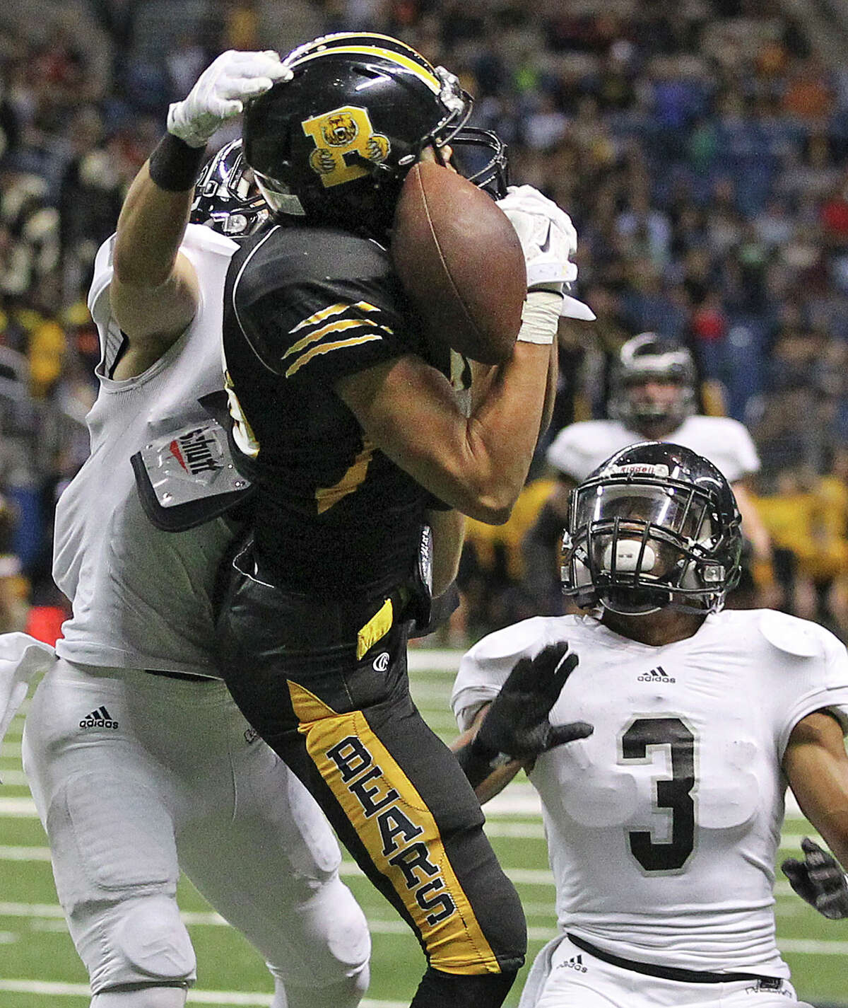 Bear receiver Dayne Thomas can't make the catch near the goal as defenders Mark Frankhouser (left) and Malik Perez pressure as Steele plays Brennan at the Alamodome in second round 6A high school Division I I playoff action on November 22, 2014.