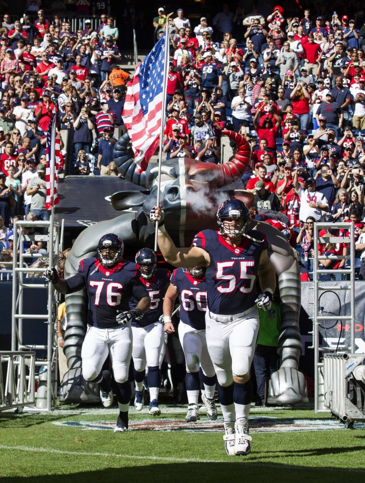 Houston Texans center Chris Myers (55) carries the American flag as he takes the field before an NFL football game against the Cincinnati Bengals at NRG Stadium on Sunday, Nov. 23, 2014, in Houston. ( Brett Coomer / Houston Chronicle )