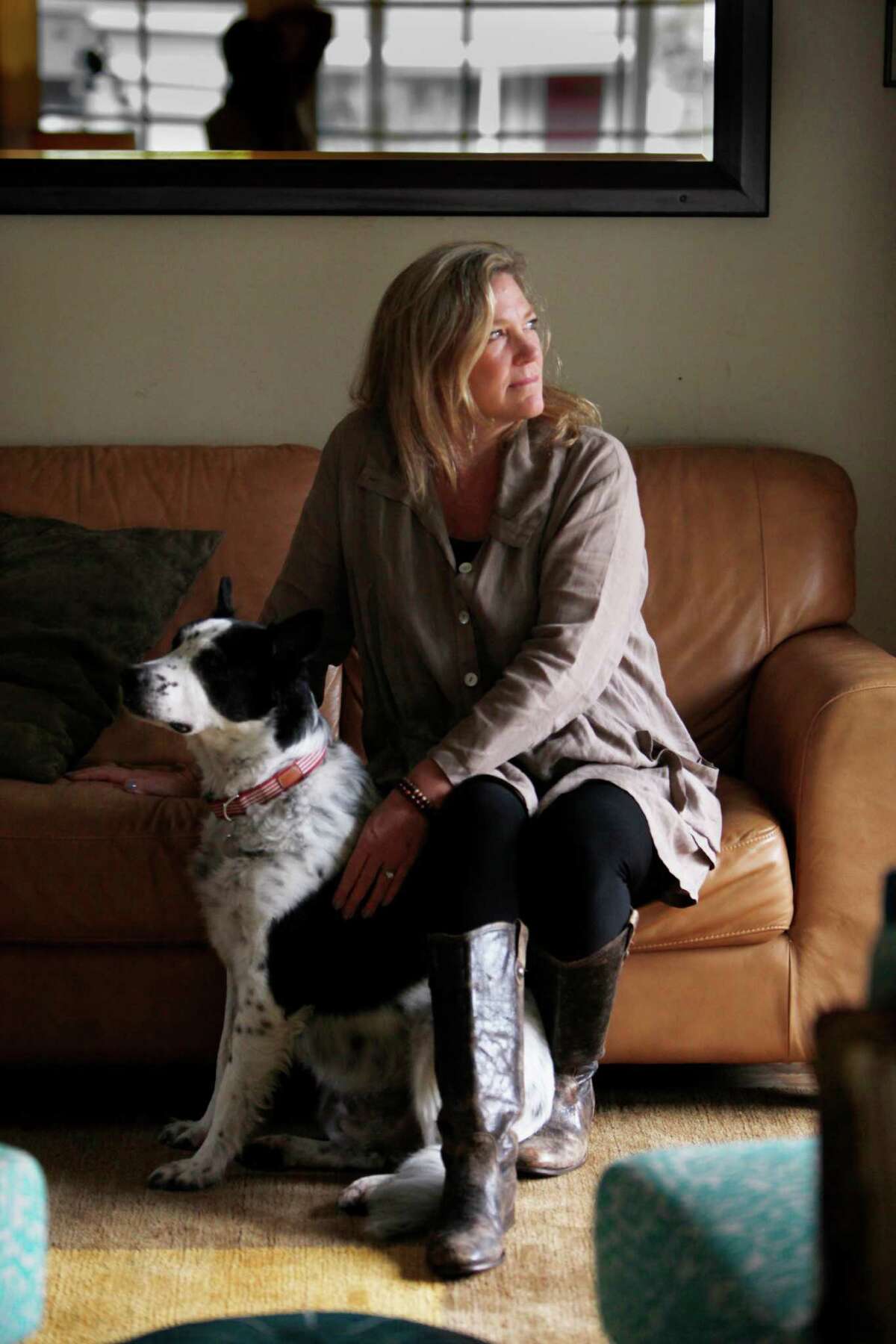 Nancy Schultz (right), widow of Dave Schultz, sits for a portrait with Truman (left) in her home on Wednesday, November 19, 2014 in San Carlos, Calif.