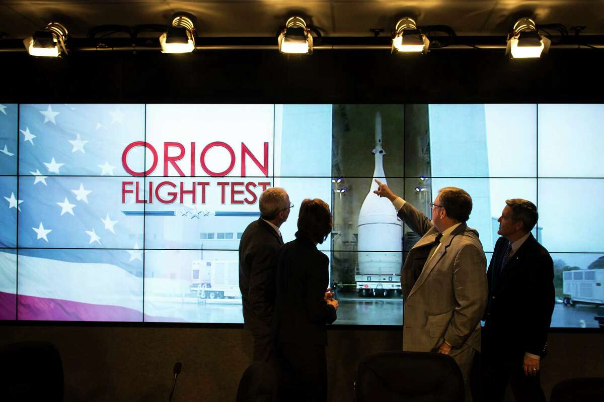 From left, Mark Geyer, Orion Program manager, Ellen Ochoa, Johnson Space Center director, Mike Hawes, Lockheed Martin Space Systems Company director of Human Space Flight Program, and Robert Cabana, Kennedy Space Center director, chat following a press conference before rollout of the Orion spacecraft in preparation for Exploration Flight Test 1 (EFT-1) on Monday, Nov. 10, 2014, at the Kennedy Space Center.