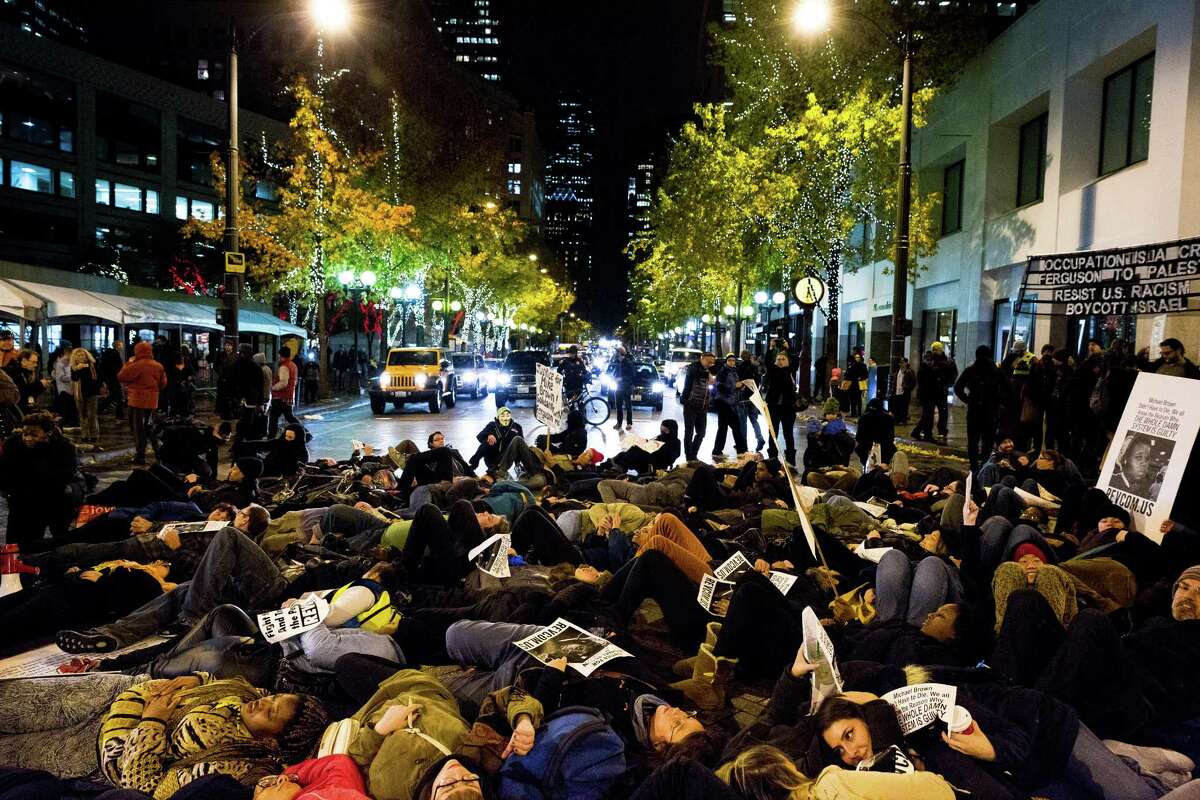 A large group of protesters stage a "die-in" on the street in response Monday in Seattle to the Ferguson grand jury decision not to indict Darren Wilson in the death of Michael Brown.