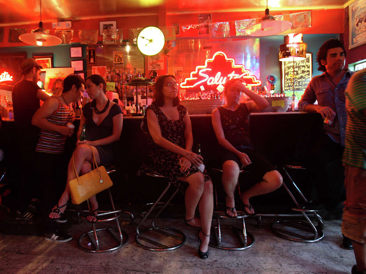 Salute (From center left) Jorge Gonzalez, Sarah Gould, Michelle Baland and Michele Nicole Simpson sit at the bar while listening to hip hop group Chisme play Sunday July 8, 2012 at Salute. The legendary nightclub hosted its last live event on July 21, 2012.