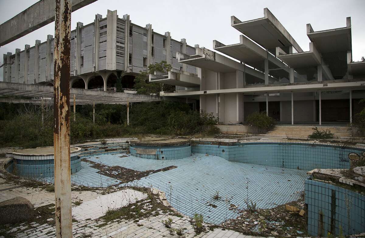 This Oct. 23, 2014, photo shows a swimming pool at the abandoned Palace hotel at deserted tourist resort of Haludovo, near Malinska on the northern Adriatic island of Krk, Croatia. The resort was built as a joint venture of Yugoslav communist government and Bob Guccione, the founder of the Penthouse magazine. The resort was intended as a haven of extreme decadence for upscale vacationers on the Adriatic Sea. Today, it sits abandoned due to ownership issues and mismanagement. 