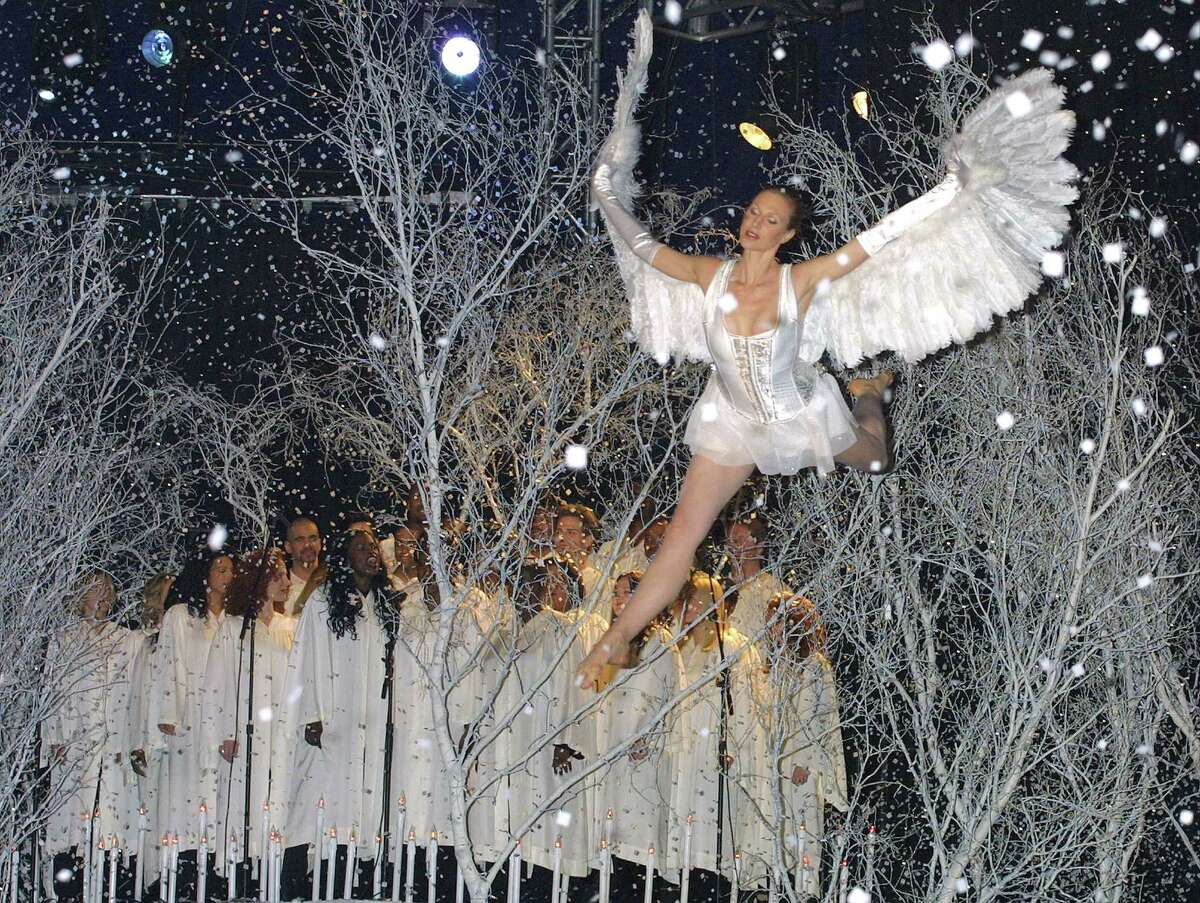 A model protraying an angel flies through the air during the Victoria's Secret Christmas Dreams and Fantasies 2001 fashion show November 13, 2001 at Bryant Park in New York City.