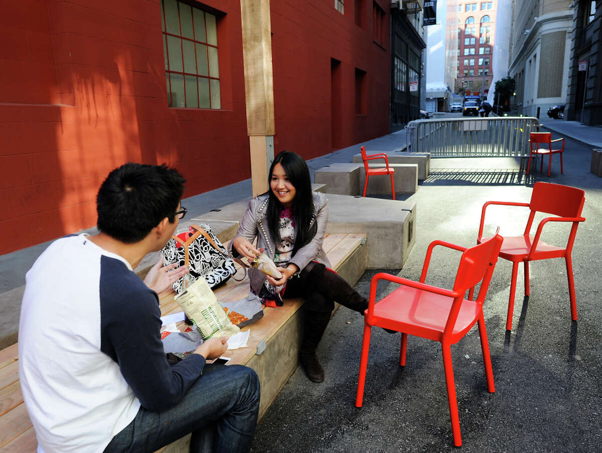 Dan Chen (left) and Andrea Lee chat over lunch in the newly designed pedestrian-friendly plaza on Annie Street.