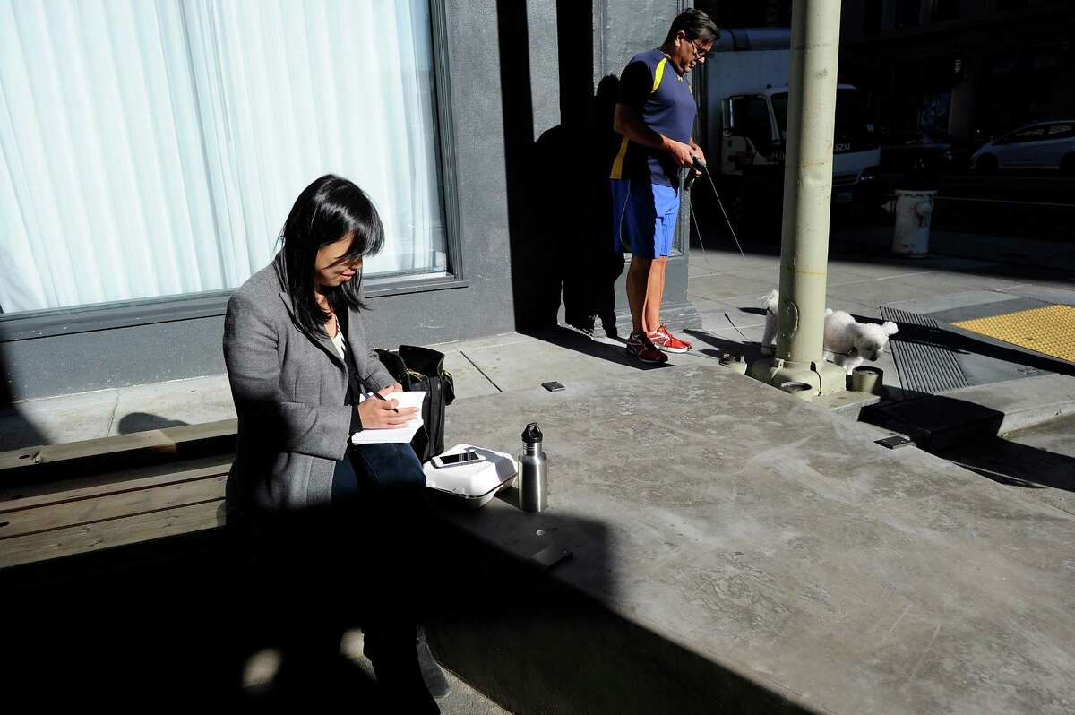 Amy Yu Gray, left, takes her lunch break from working at nearby SFMOMA offices at the newly designed, pedestrian friendly plaza on Annie Street in San Francisco CA, on Monday, November 24, 2014.