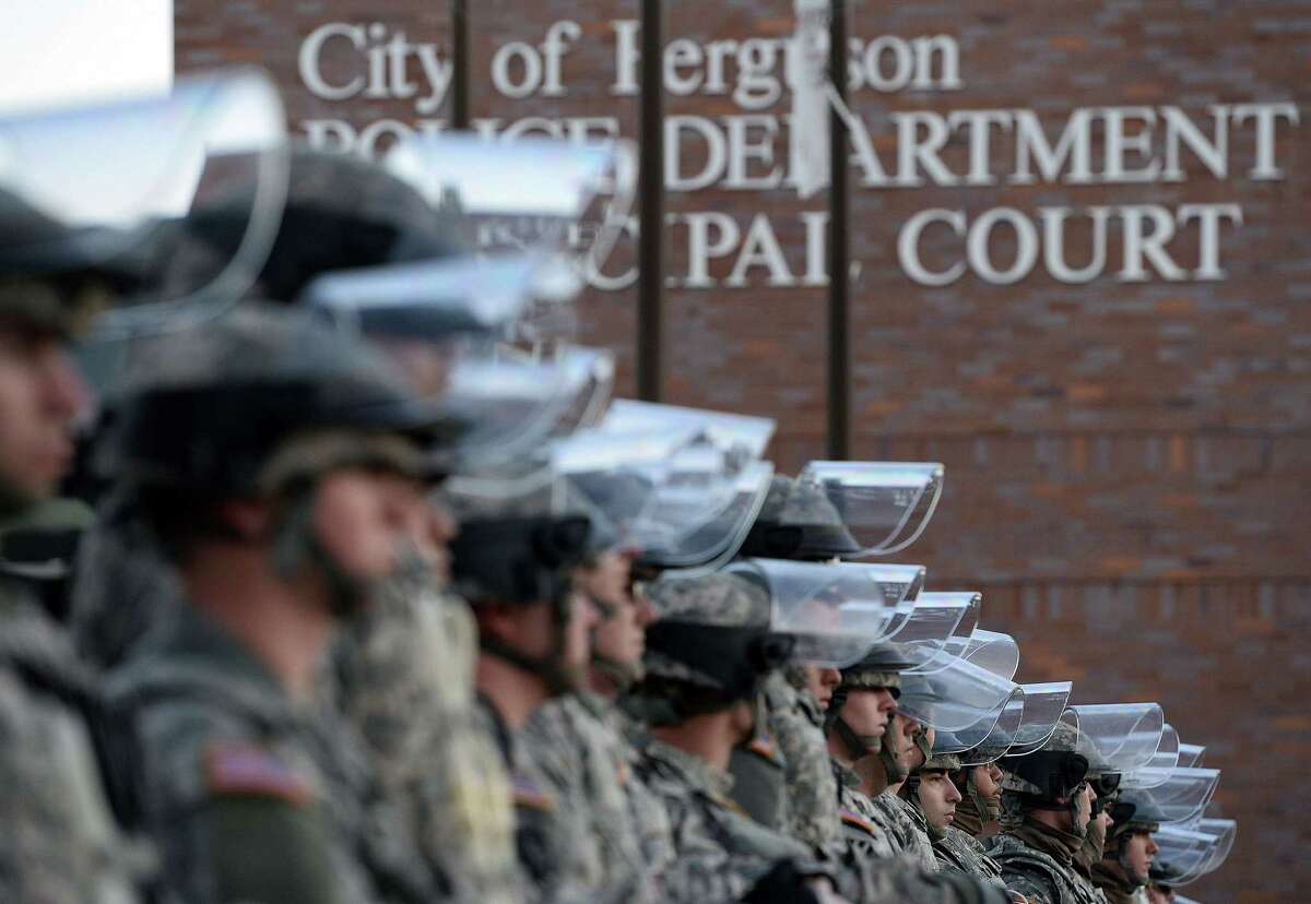 National Guard troops secure the police station in Ferguson, Mo., on Tuesday, a day after the grand jury opted not to indict the officer who shot Michael Brown.﻿