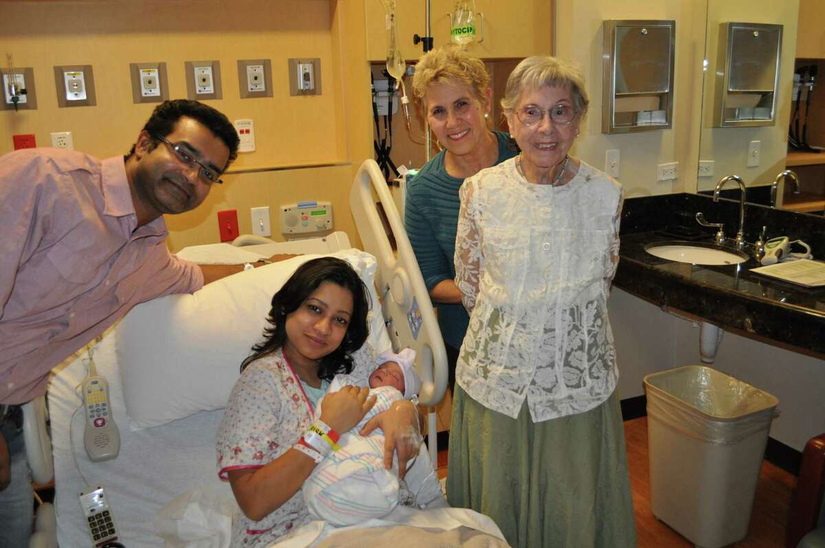 100-year-old Janet Unger and her daughter, Joan Davis, far right, visit Kushan Biswas, far left, and Tonima Paul and their baby girl, Utsa Biswas, to commemorate Janet's centennial birthday.