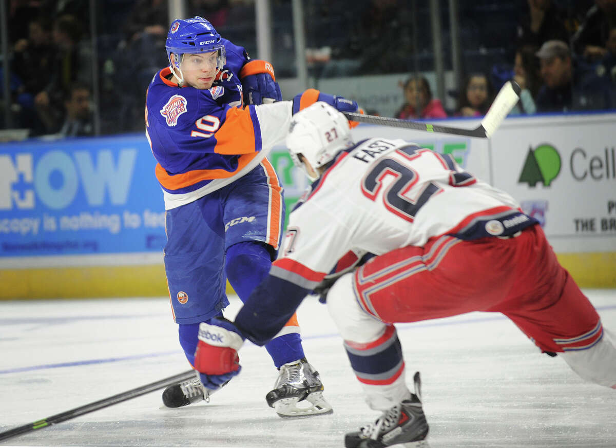 Sound Tiger Scott Mayfield fires a shot on goal while being defended by Hartford's Jesper Fast in the second period of their AHL hockey game at the Webster Bank Arena in Bridgeport, Conn. on Sunday, March 30, 2014.