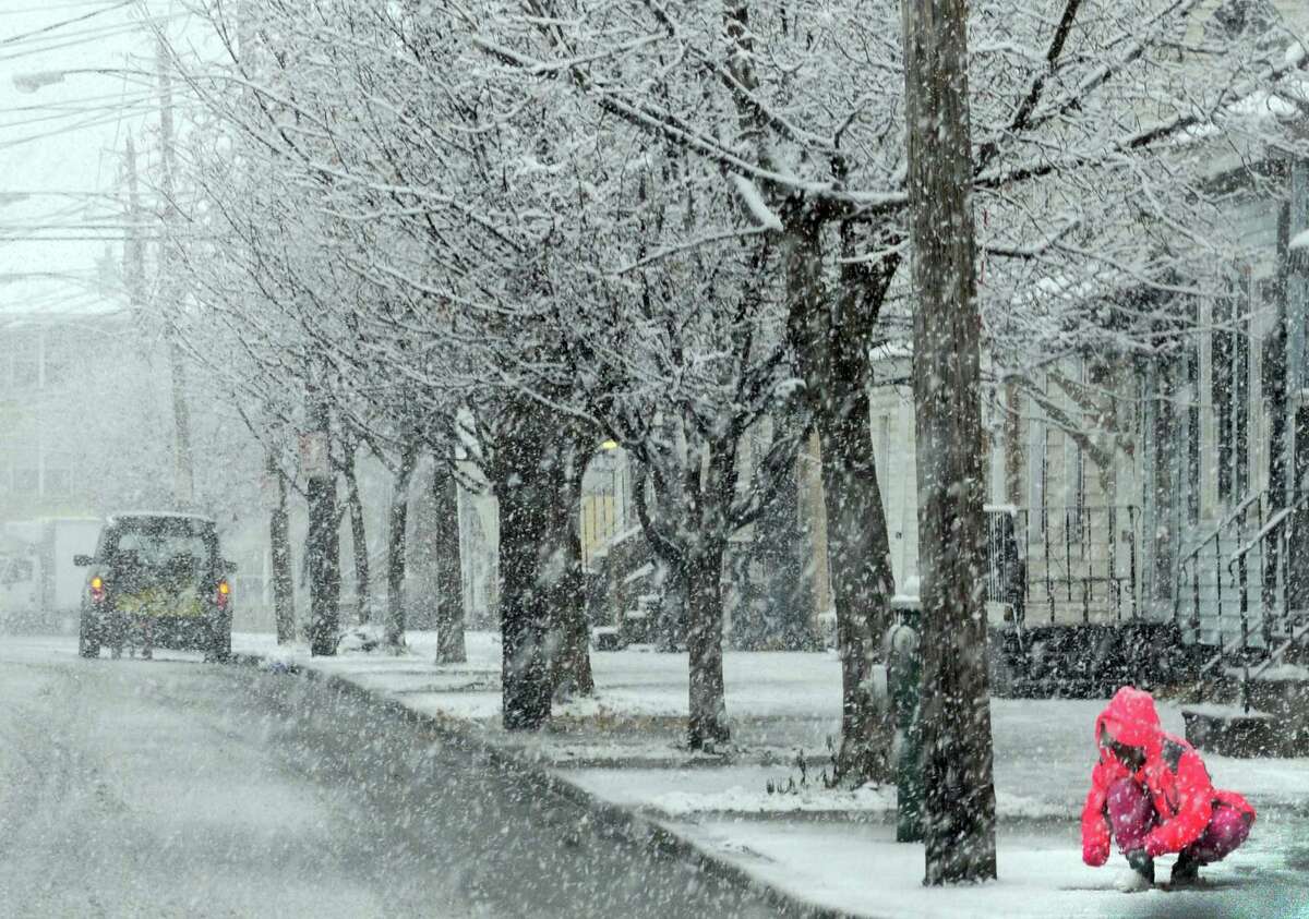 Nov. 26-27, 2014: A snowstorm the day before Thanksgiving dropped nine to 13 inches of snow on the Capital Region, posing major travel problems. A young girl tries to gather snow on Ontario Street in Albany as a winter storm begins to hit the Capital Region on Nov. 26, 2014.