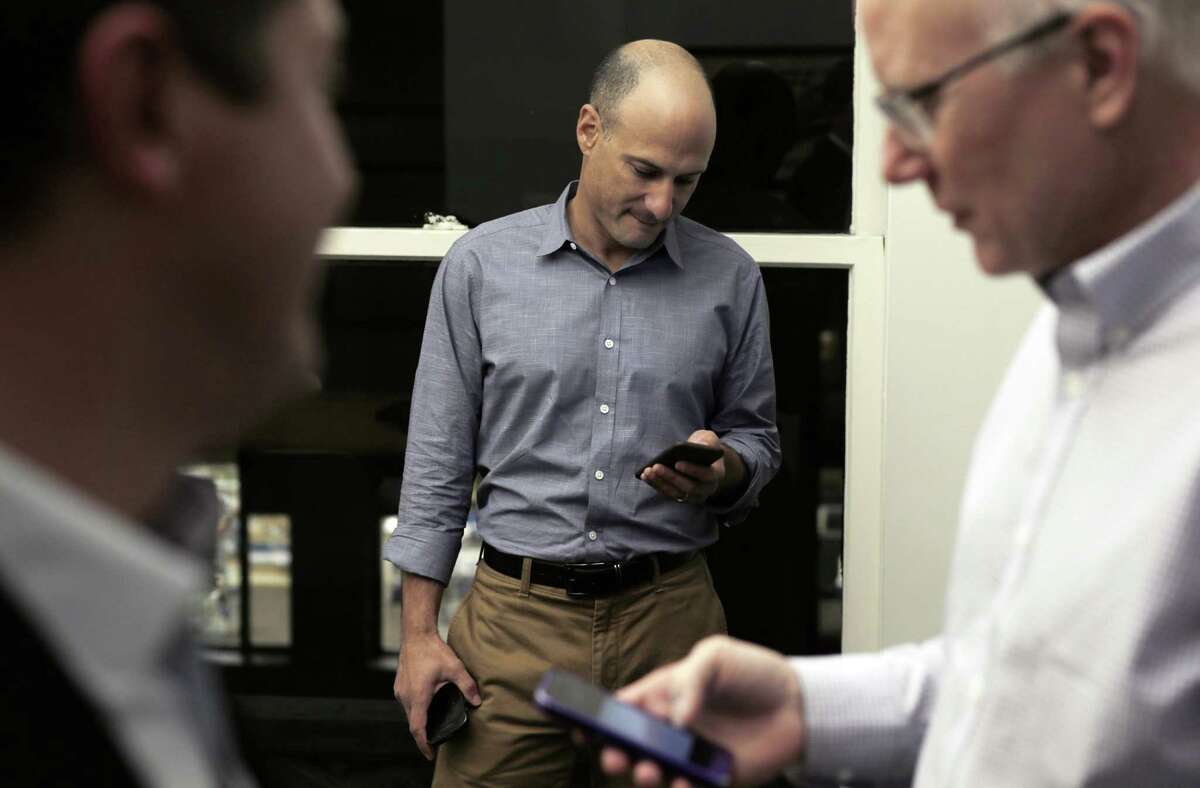 L-R, Sean Clegg, Dan Newman, and Ace Smith check their smarphones in their offices at SCN Strategies in San Francisco, Calif., on Sunday, November 23, 2014. The 2014 elections marked a dismal result for democrats across the nation, but local political strategists Ace Smith, Dan Newman, and Sean Clegg, notched a perfect 10 for 10 with wins in big races for clients like Jerry Brown, Kamala Harris, Libby Schaff, and Gavin Newsom.