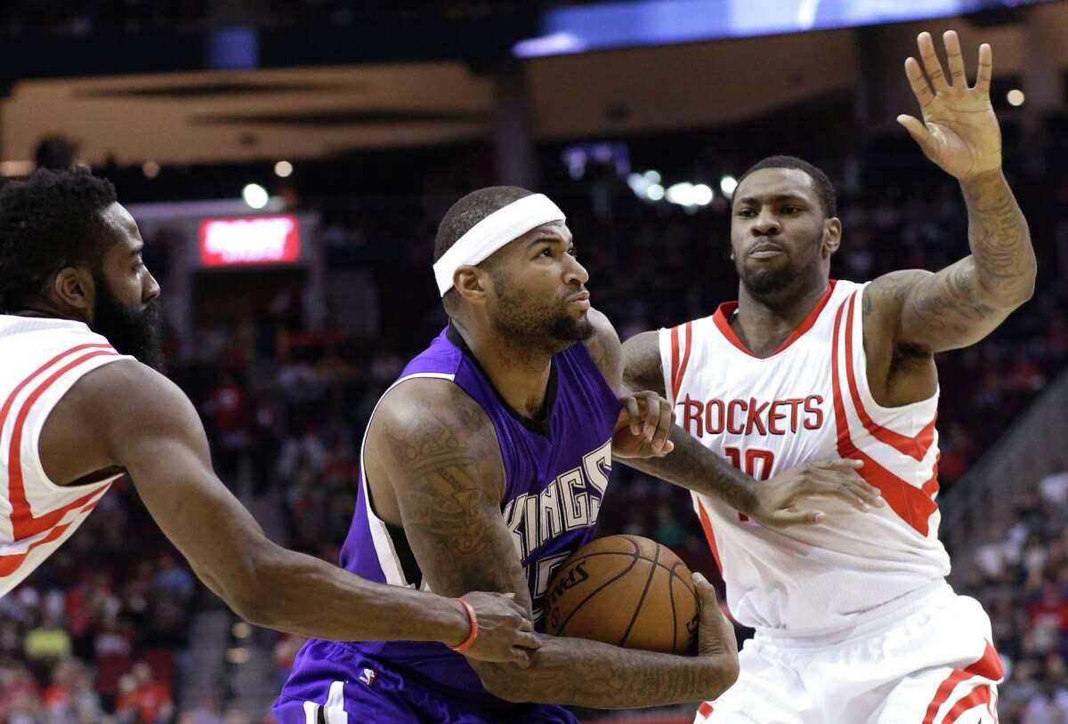 The Kings' DeMarcus Cousins, left, is one tough customer for any defender, much less one nursing an eye infection as Tarik Black was in Wednesday's game.