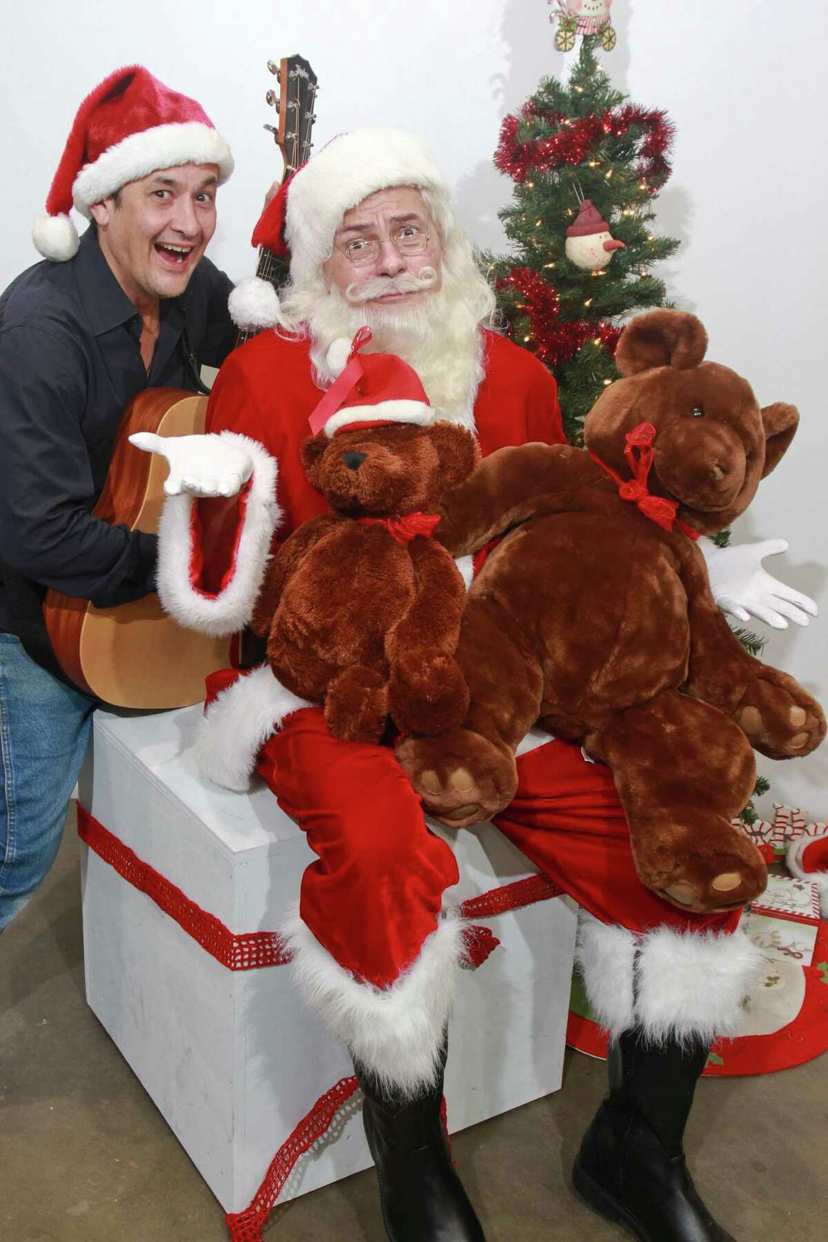 Luis Galindo, left, and Scott Burkell as Santa, in this scene from the Stark Naked Theatre Company's premiere comedy "Ho Ho Humbug" written by and starring Scott Burkell. (For the Chronicle/Gary Fountain, November 22, 2014)