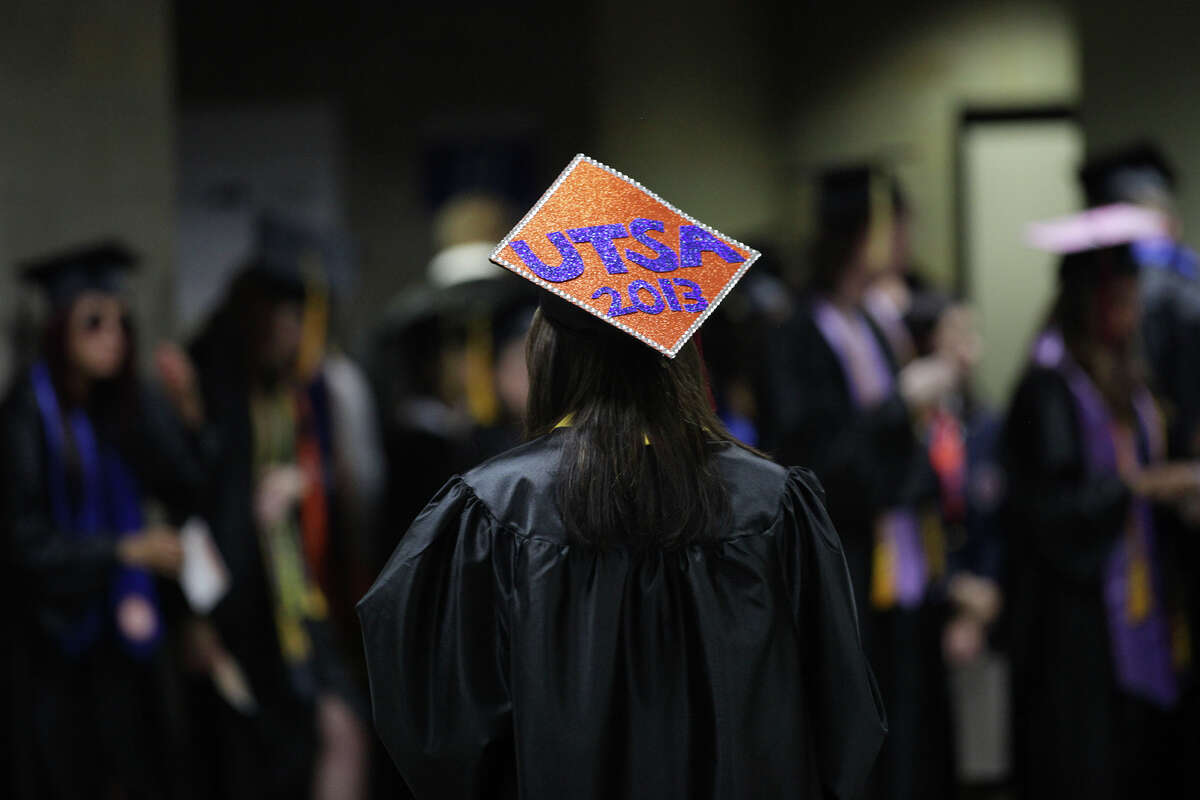 In this file photo, a 2013 graduate decorates her cap for a University of Texas at San Antonio graduation ceremony. Business groups want to see more students graduate faster.