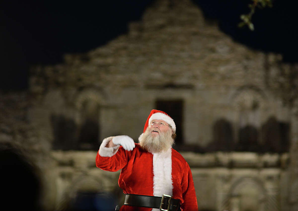 Santa Claus himself watches as the city's official Christmas tree is lit at the 30th Annual H-E-B Christmas Tree Lighting Celebration in Alamo Plaza on Friday, Nov. 28, 2014.