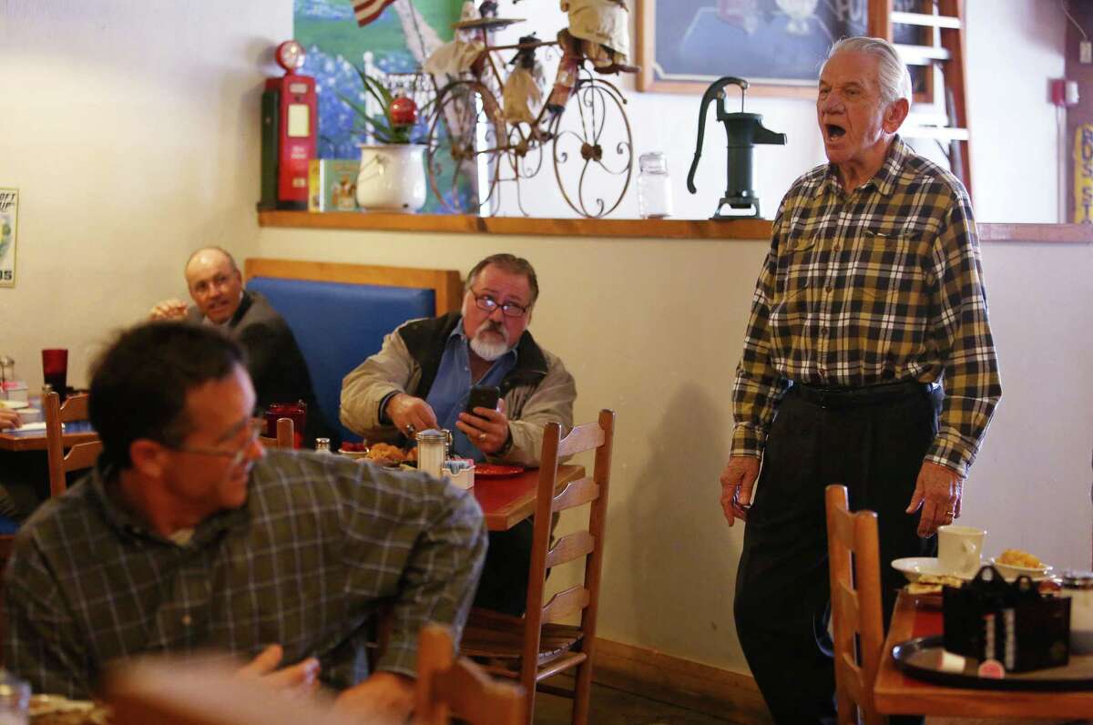 Tom Ott, owner of Humble City Café, sings ﻿to patrons during the lunch rush. Residents are trying to preserve the small-town identity of Old Humble amid the development all around it.