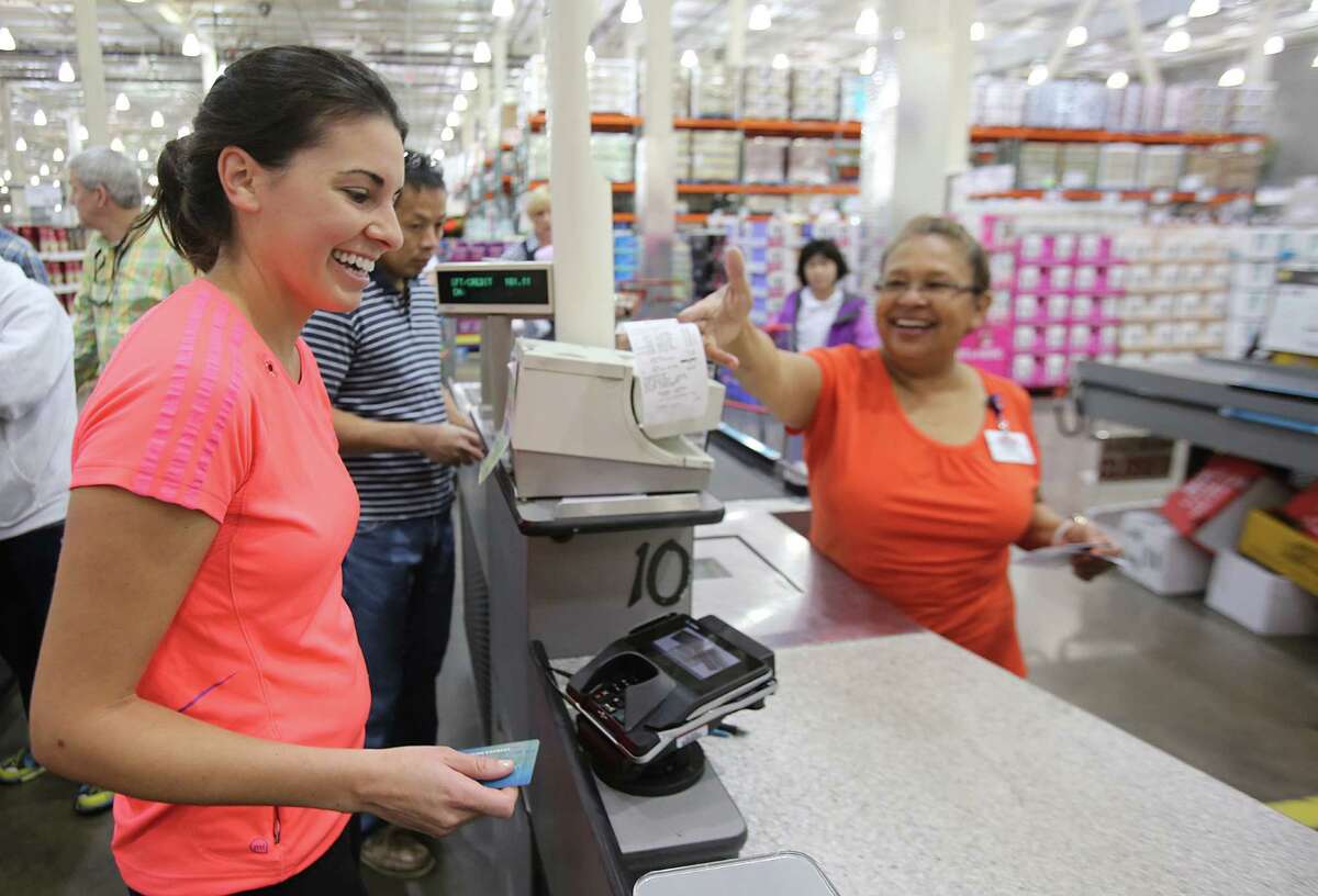 Kristen Adams, left, shops at a Houston Costco. New technologies can help consumers in the fight against hackers. ﻿