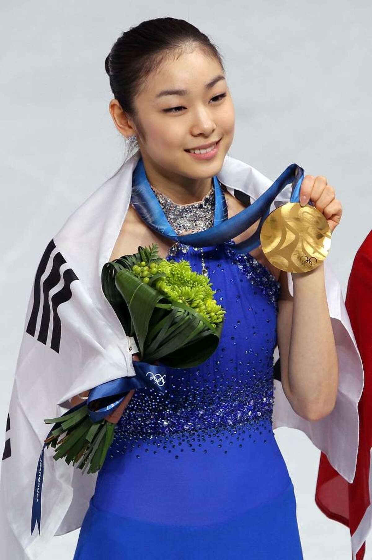 VANCOUVER, BC - FEBRUARY 25: Kim Yu-Na of South Korea celebrates winning the gold medal in the Ladies Free Skating during the medal ceremony on day 14 of the 2010 Vancouver Winter Olympics at Pacific Coliseum on February 25, 2010 in Vancouver, Canada. (Photo by Matthew Stockman/Getty Images) *** Local Caption *** Kim Yu-Na