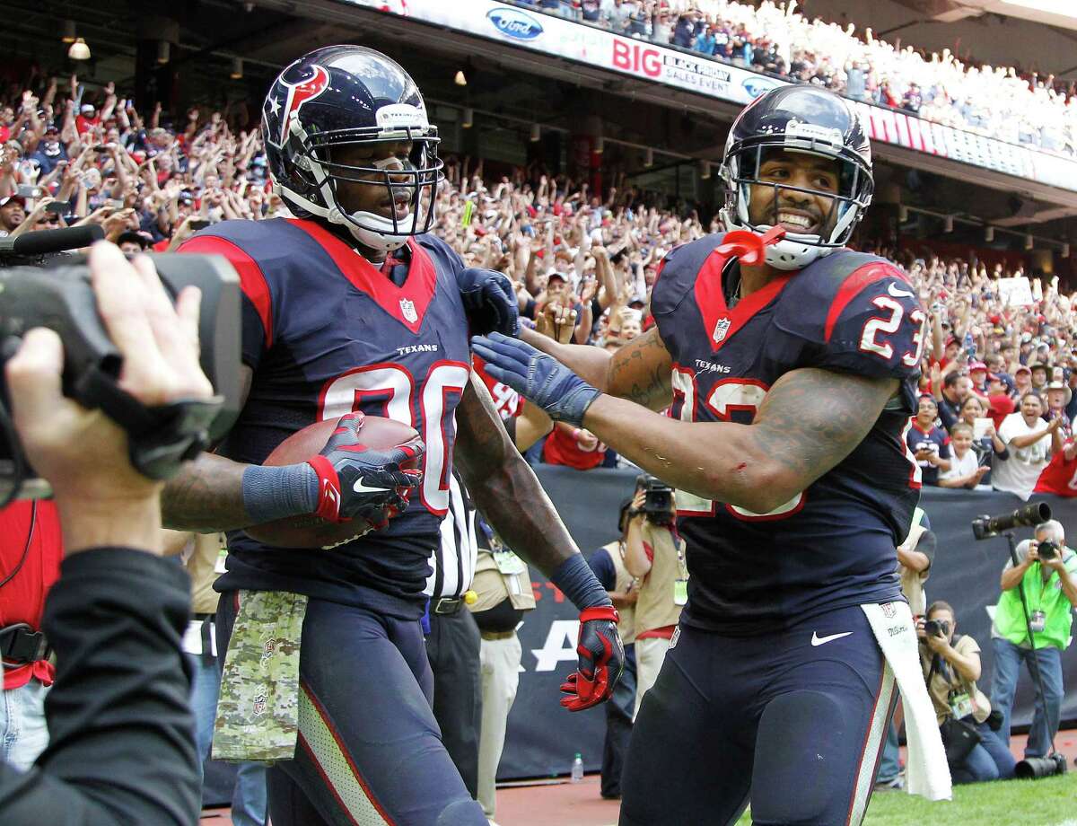 Houston Texans wide receiver Andre Johnson (80) celebrates his touchdown with Texans Arian Foster (23) during the fourth quarter at an NFL football game at NRG Stadium, Sunday, Nov. 30, 2014, in Houston.