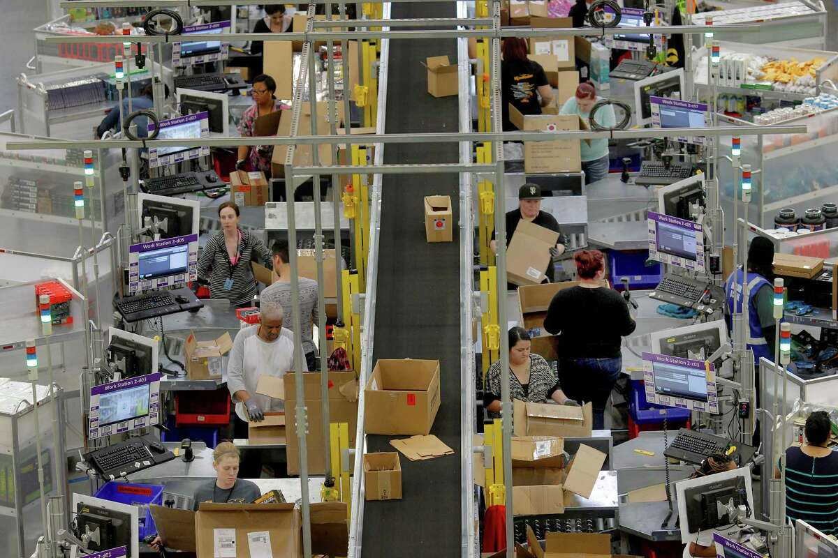 The Amazon.com fulfillment center in Tracy uses robotic assistance to get orders ready for shipment. In a case brought by Nevada workers, the Supreme Court said security screenings are not paid time.