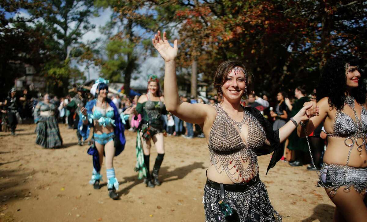 Festival actors parade through the crowd at the Texas Renaissance Festival Saturday, Nov. 29, 2014, in Todd Mission. Sunday is the last day for the festival this year.