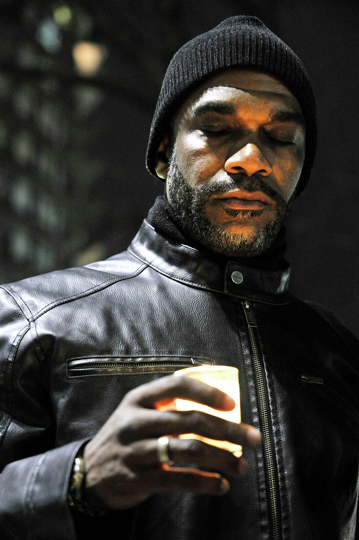 Scotty Schmidt holds a candle as a prayer is offered during the NAACP rally at the Stamford Government Center in Stamford, Conn., on Sunday, Nov. 30, 2014. The rally was in response to the St. Louis grand jury failing to indict Ferguson Police Officer Darren Wilson in the shooting death of Michael Brown Jr.