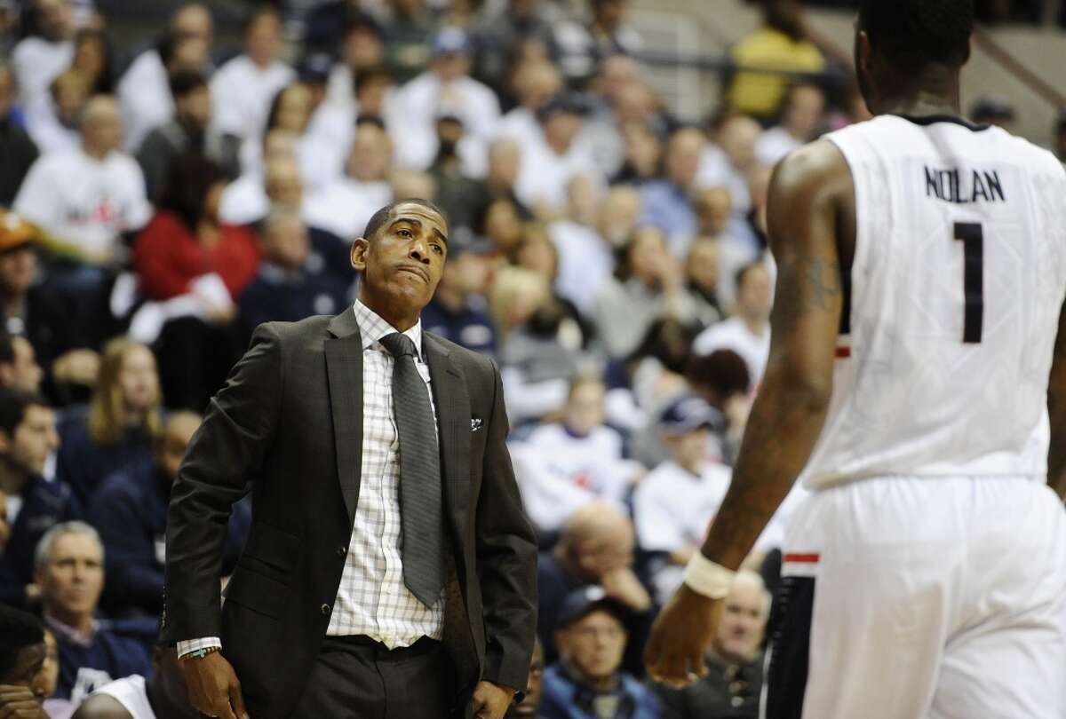 Connecticut head coach Kevin Ollie, left, reacts toward Connecticut?’s Phillip Nolan, right, during the first half of an NCAA college basketball game, Sunday, Nov. 30, 2014, in Storrs, Conn. (AP Photo/Jessica Hill)