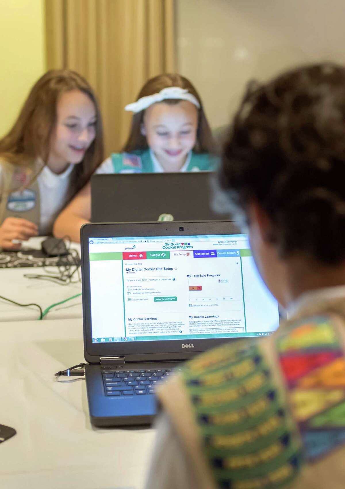In this undated photo released from Girl Scouts of the USA, Girl Scouts Olivia and Isabella practice selling cookies on one of two new digital platforms. It’s the first time Girls Scouts of the USA has allowed sale of cookies using a mobile app and personalized websites. The Digital Cookie program is intended to enhance, not replace, traditional use of paper spreadsheets.
