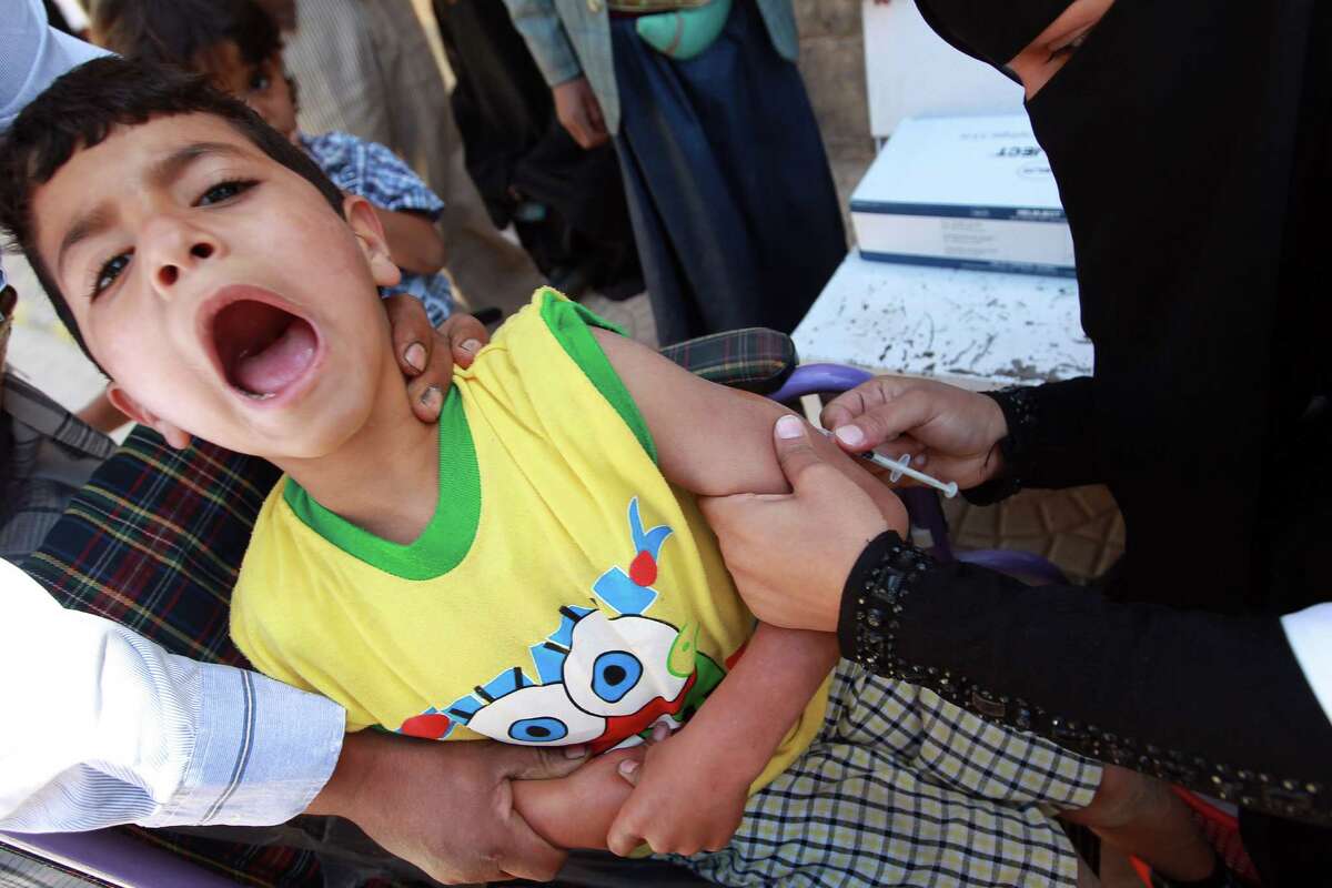 A doctor administers a measles vaccine to a Yemeni child during an immunization campaign at a health center on November 10, 2014, in the capital Sanaa ( AFP/Getty Images).