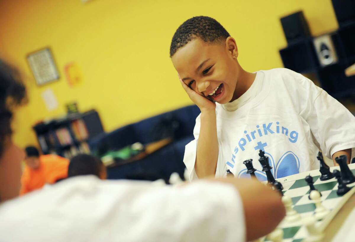 Alijza, 7, reacts to his opponent's chess move at the InspiraKing Chess Club at the Inspirica children's shelter in Stamford, Conn. Monday, Dec. 1, 2014. Brunswick School fifth-graders Lucas Korn and Max Konzerowsky started the club to share their love of chess with children at the shelter while helping them build strategic and creative thinking skills.