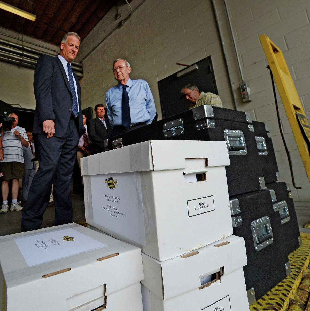 Capital OTB's John Signor, left and Rensselaer Mayor Dan Dwyer, right watch as the Rensselaer casino bid documents are delivered at the New York State Gaming building Monday morning June 30, 2014 in Schenectady, N.Y. The deadline for bids to hold a license for one of seven full service casinos in New York State ended Monday at 4 p.m. (Skip Dickstein / Times Union)