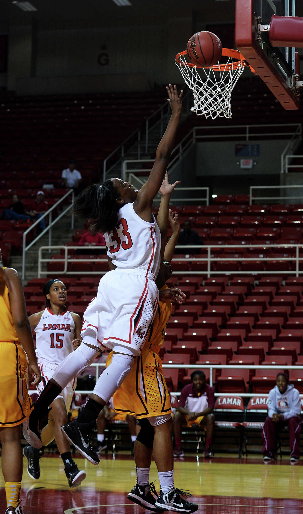 Lamar's Kiandra Bowers, No. 33, jumps for a shot against Huston-Tillotson on Tuesday. The Lamar Lady Cardinals hosted Huston-Tillotson Lady Rams at the Montagne Center on Tuesday night. Photo taken Tuesday 12/2/14 Jake Daniels/The Enterprise