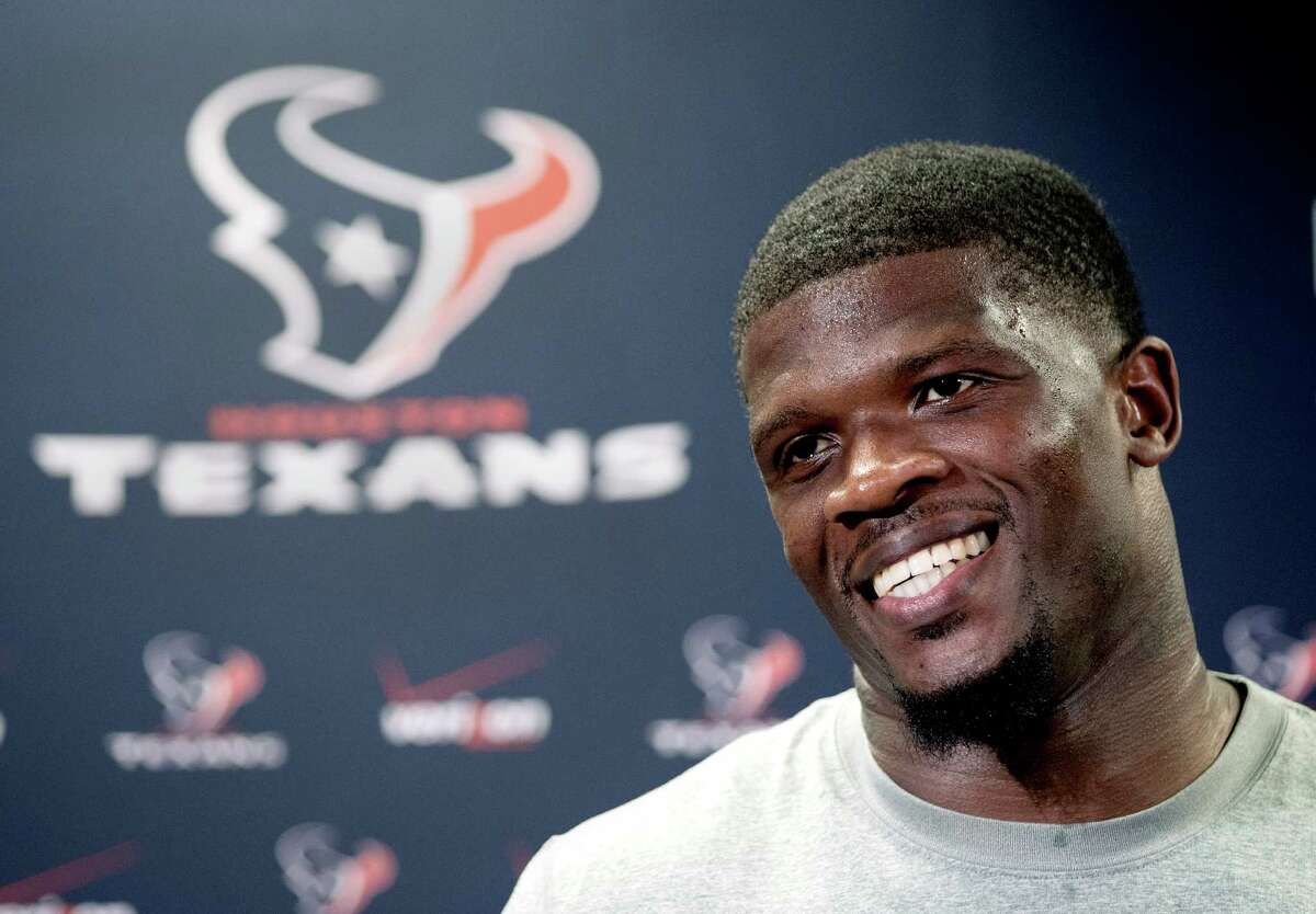 Houston Texans wide receiver Andre Johnson smiles as he answers a question after reporting for NFL football training camp Friday, July 25, 2014, in Houston. The Texans begin practices Saturday. (AP Photo/David J. Phillip)