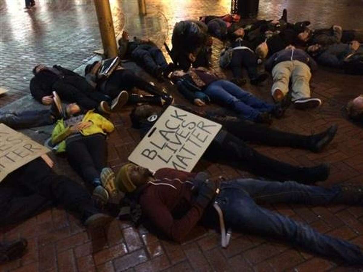 Protesters lie on the ground near the Powell St. cable car turnaround in San Francisco on Wednesday, Dec. 3, 2014, in protest of a grand jury's decision not to indict an NYPD officer in the chokehold death of Eric Garner.