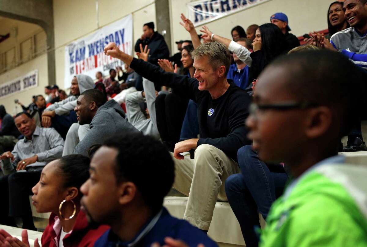 Warriors coach Steve Kerr cheers on Richmond High School during the team’s game against Concord High after the death of guard Rodney Frazier.