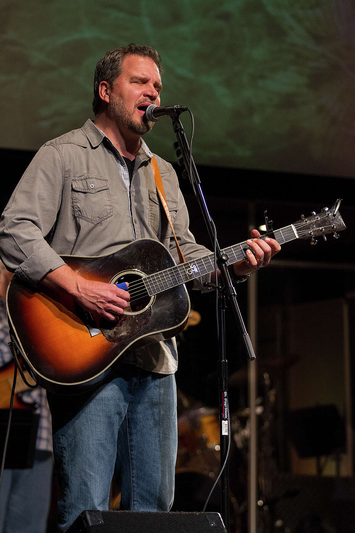 Pastor Sean Azzaro closes a recent service with a song at River City Community Church. He is releasing his debut album Sunday evening at Sam’s Burger Joint.