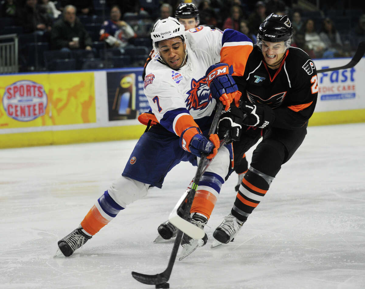 Sound Tiger Scooter Vaughan, left, races in on net defended by Adirondack defenseman Mark Alt in the 3rd period of the Soundtigers 5-4 AHL hockey win at the Webster Bank Arena in Bridgeport, Conn. on Sunday, March 16, 2014.