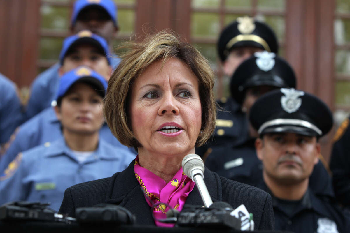 San Antonio City Manager Sheryl Sculley (front, center) speaks to the media at City Hall March 27, 2012, about the police department's initiative to recruit new police officers Behind Sculley are police cadets (left, light blue) and police officers (right).